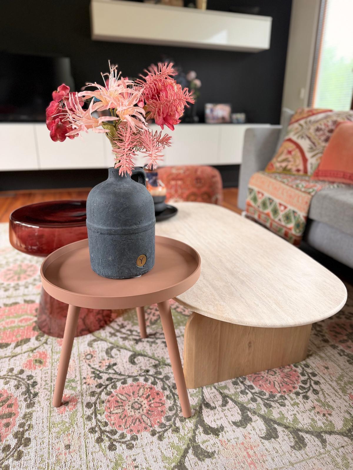 Bijzettafel met vaas en bloemen in een woonkamer